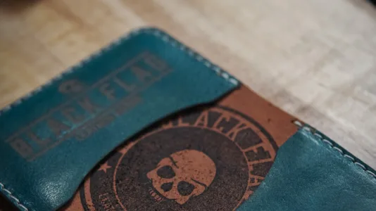 Close up of stamp on leather minimalist bifold cardholder